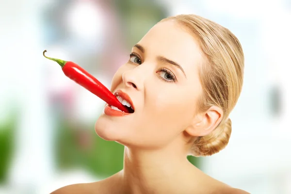 Lycklig naken kvinna med chili i hennes mun — Stockfoto
