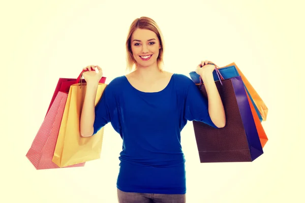 Mulher com um monte de sacos de compras. — Fotografia de Stock