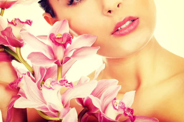 Beautiful woman with pink flower. Stock Image
