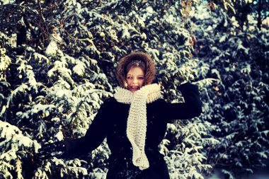 Young woman throwing snowball