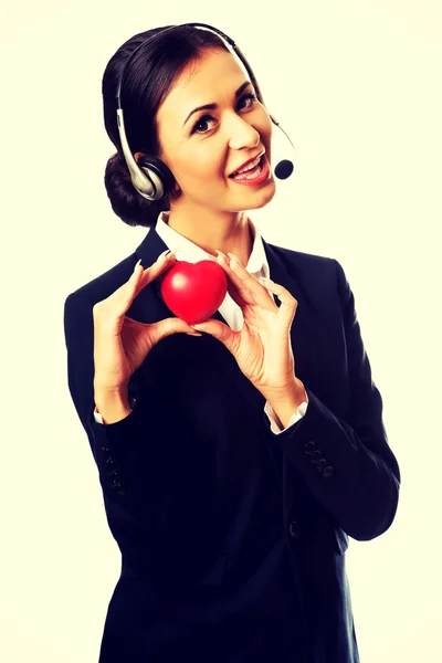 Call center woman holding heart model — Stock Photo, Image