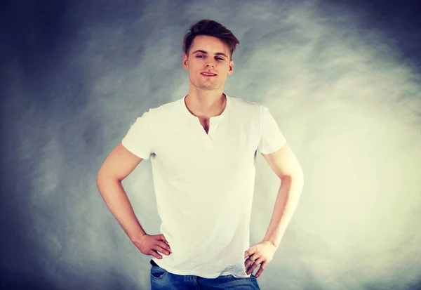 Joven hombre sonriente con las manos en las caderas . — Foto de Stock