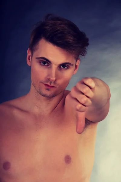 Upset man with thumbs down. — Stock Photo, Image