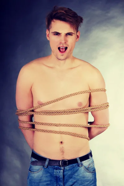 Tortured man tied with a rope. — Stock Photo, Image
