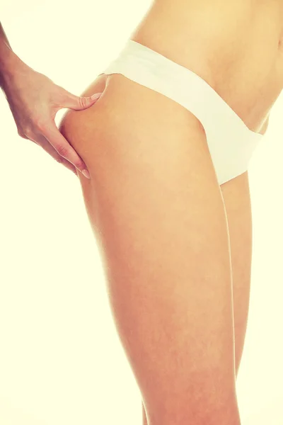 Slim woman pinching her buttocks. — Stock Photo, Image