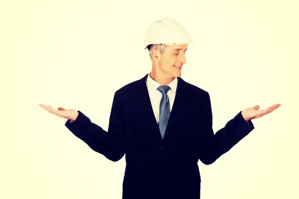 Businessman with hard hat holding copyspace — Stock Photo, Image