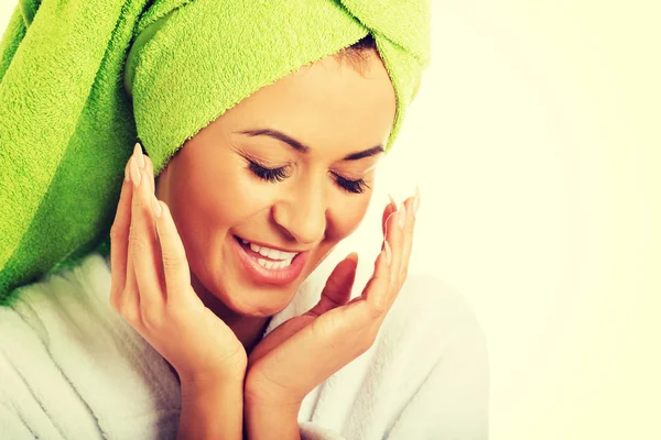 Woman in bathrobe touching face — Stock Photo, Image