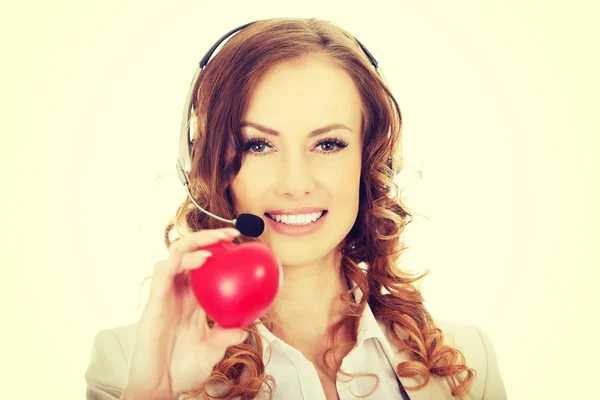 Call center woman with heart toy. — Stock Photo, Image