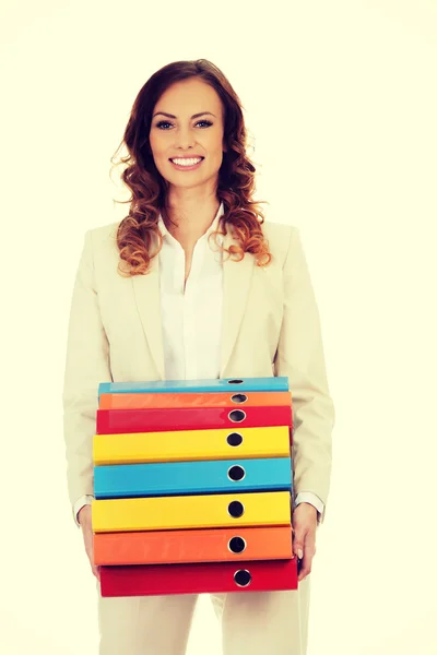 Female carrying heavy binders against. — Stock Photo, Image