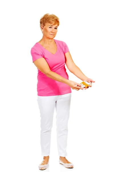 Senior woman holding few tablets package — Stock Photo, Image