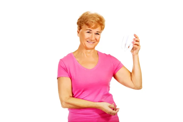 Gülümseyen kadın kıdemli bir diş model holding — Stok fotoğraf