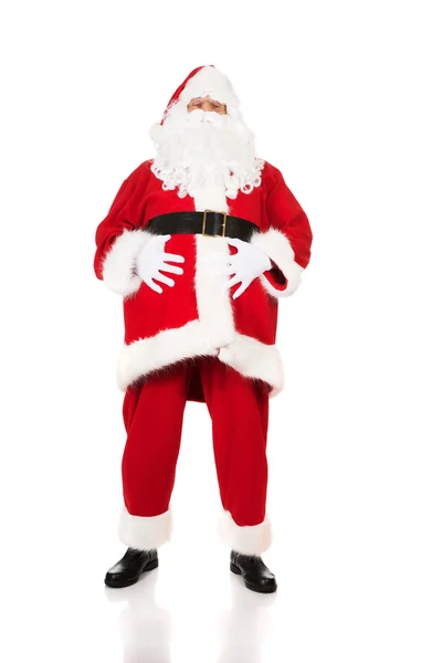 Happy Santa Claus holding his fat belly — Stock Photo, Image