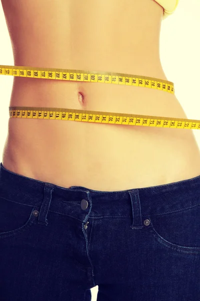 Slim womans body with measuring tape. — Stock Photo, Image