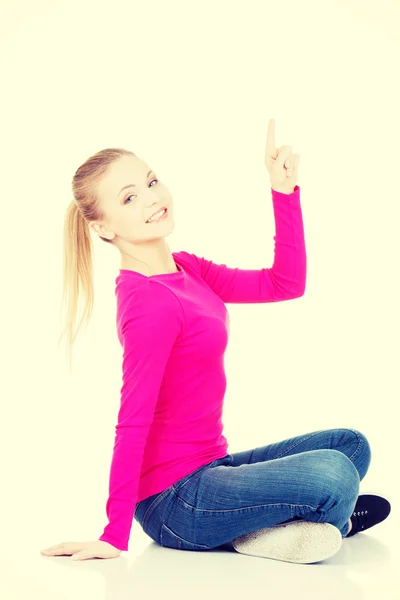 Young beautiful casual woman pointing up. — Stock Photo, Image