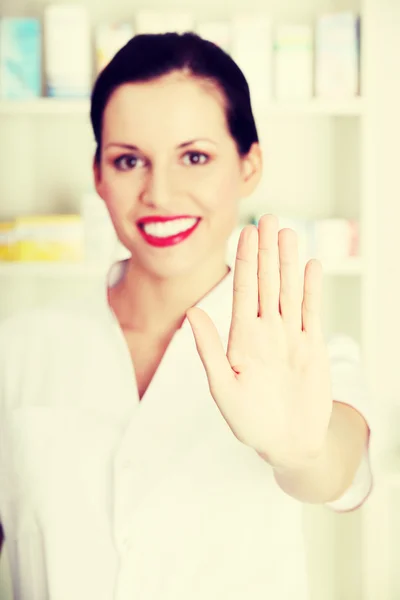 Druggist woman makes stop sign. — Stock Photo, Image