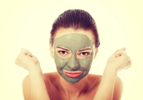 Beautiful woman with clay facial mask — Stock Photo, Image