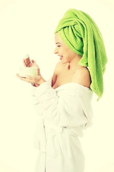 Woman in bathrobe with cream — Stock Photo, Image