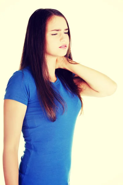 Young casual woman is touching her neck. — Stock Photo, Image