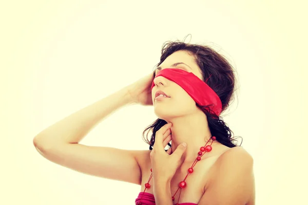 Young beautiful brunette with red eyeband and necklace. — Stock Photo, Image
