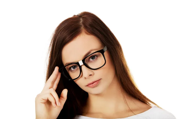 Mujer joven sosteniendo sus gafas — Foto de Stock
