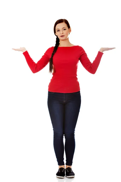 Young smiling woman presenting something on open palms — Stock Photo, Image