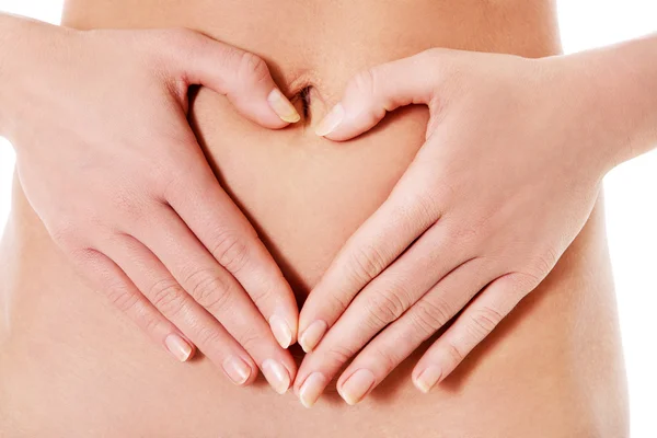 Lichaamsverzorging, zwangerschap dieet concept, vrouw hand in hand op de maag. — Stockfoto