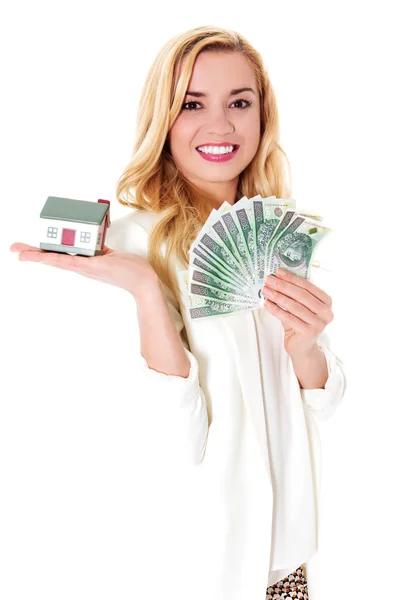 Attractive woman showing dollar banknotes and small house. — Stock Photo, Image