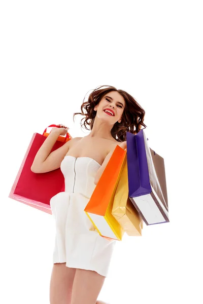 Mulher bonita com sacos de compras saltando — Fotografia de Stock