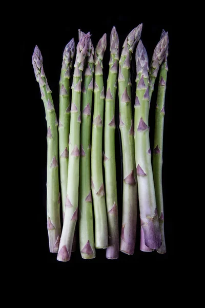 Raw asparagus on black background — Stock Photo, Image