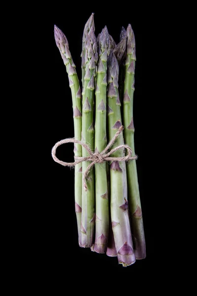 Raw asparagus on black background — Stock Photo, Image