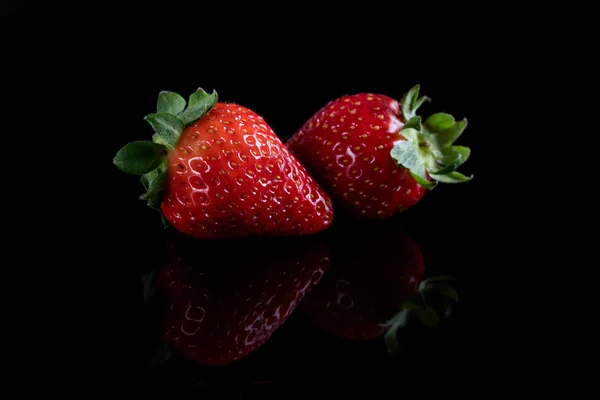 Two juicy strawberry on black background — Stock Photo, Image