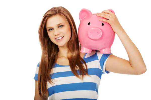 Happy teenage woman holding piggybank — Stock Photo, Image