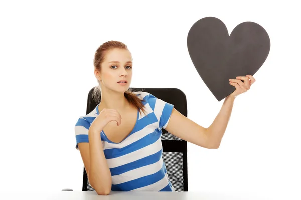 Beautiful teenage woman holding paper heart — Stock Photo, Image