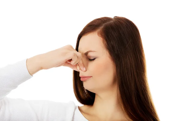 Young woman holding her nose because of a bad smell — Stock Photo, Image