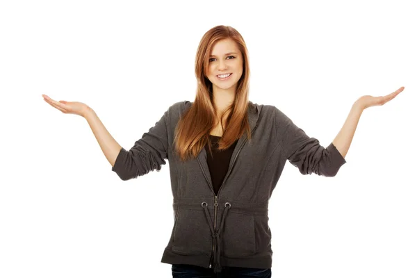 Teenage woman presenting something on both palms — Stock Photo, Image