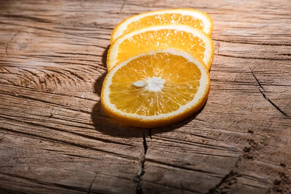 Orange slices on wooden board — Stock Photo, Image