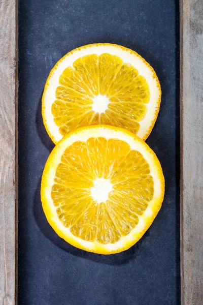 Two juicy slices on black board — Stock Photo, Image