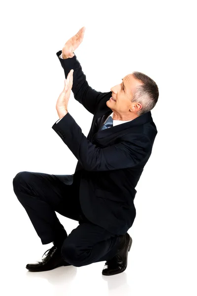 Businessman protecting himself from empty space — Stock Photo, Image