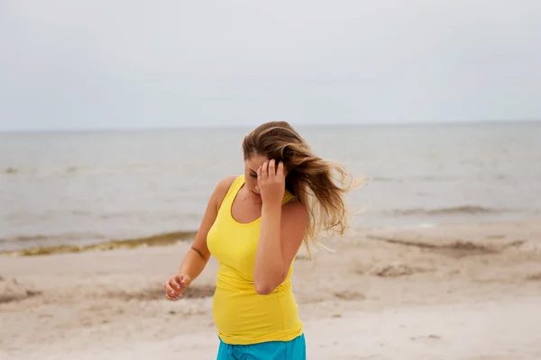 Tired woman standing on the beach — Stock Photo, Image