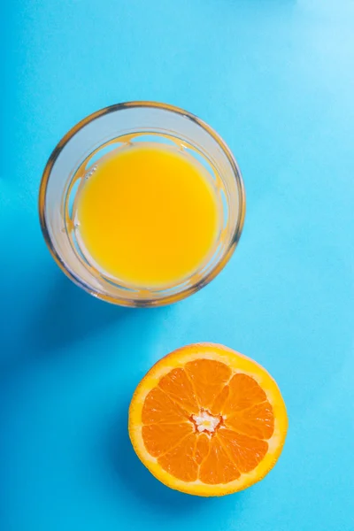 Copo de suco de laranja e metade de laranja — Fotografia de Stock