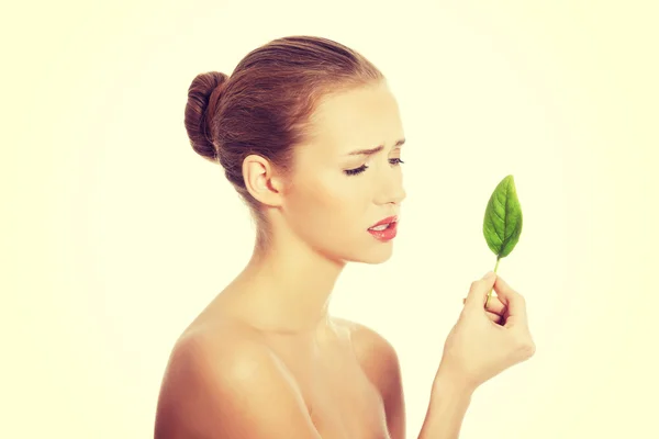 Beautiful woman with one green leaf. — Stock Photo, Image