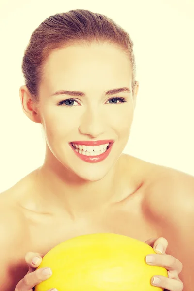 Beautiful woman holding fresh yellow melon. — Stock Photo, Image