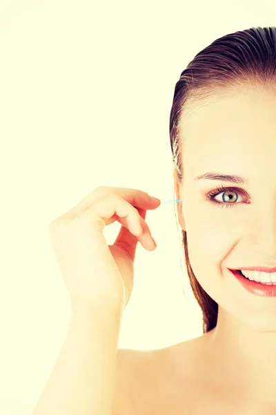 Woman cleaning up an ear with a swab — Stock Photo, Image