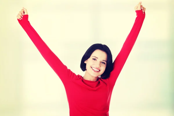 Mujer joven emocionada con los puños en alto —  Fotos de Stock