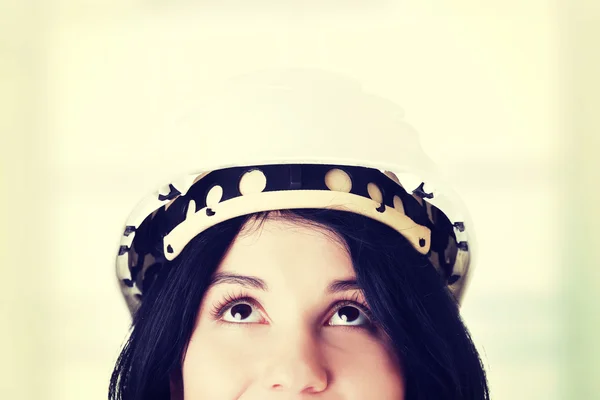 Portrait of female worker in helmet looking up. — Stock Photo, Image