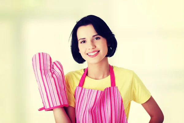 Jeune femme au foyer en tablier rose ang gant — Photo