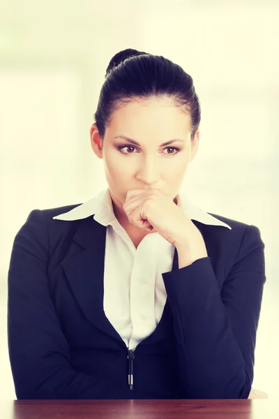 Sad business woman sitting behind the desk — Stock Photo, Image