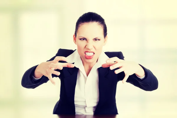 Angry businesswoman at the desk — Stock Photo, Image