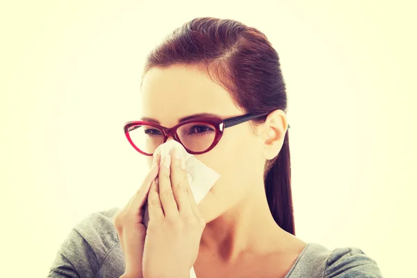 Young casual woman blowing her nose. — Stock Photo, Image