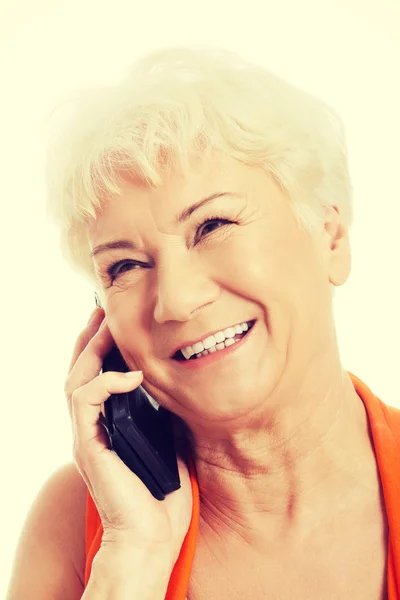 An old woman talking through phone. — Stock Photo, Image